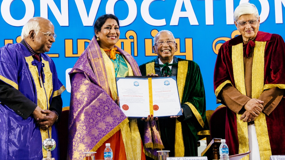 Narthaki Nataraj holding her honorary doctorate certificate at a convocation ceremony